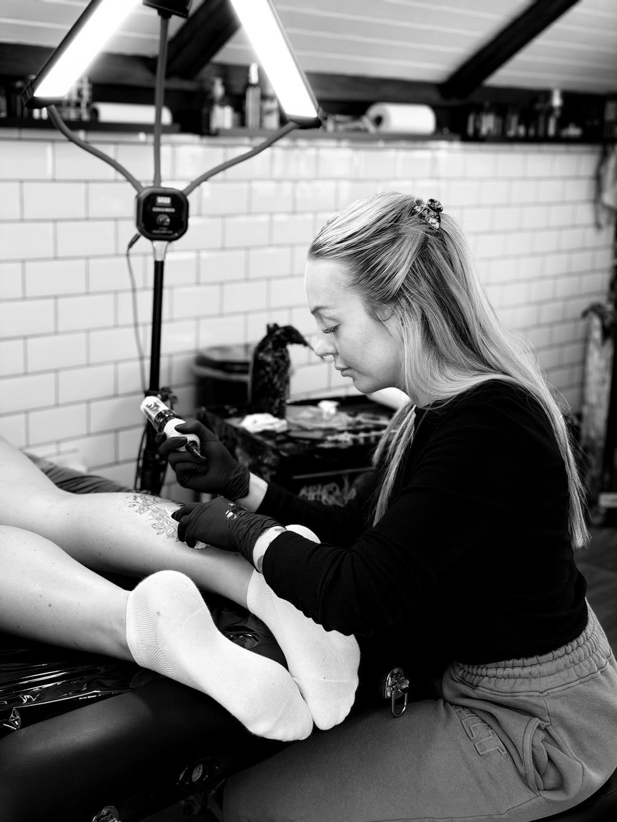 Tattoo artist at work in the studio